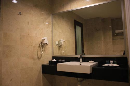 
a bathroom with a sink and a mirror at Tower Regency Hotel & Apartments in Ipoh
