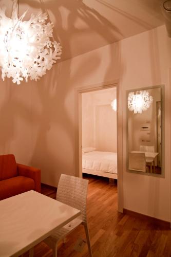 a dining room with a table and a mirror at Hotel Cave Del Sole in Matera