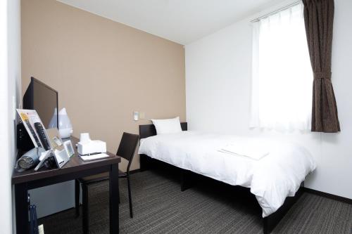 Ein Bett oder Betten in einem Zimmer der Unterkunft Value The Hotel Naraha Kido Ekimae