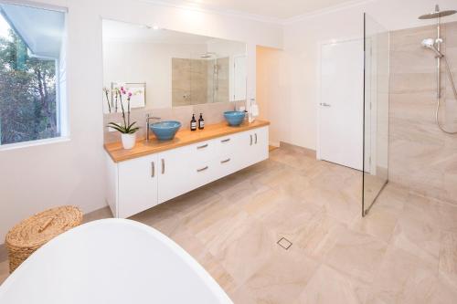 a bathroom with two sinks and a shower at Yaringa in Dunsborough