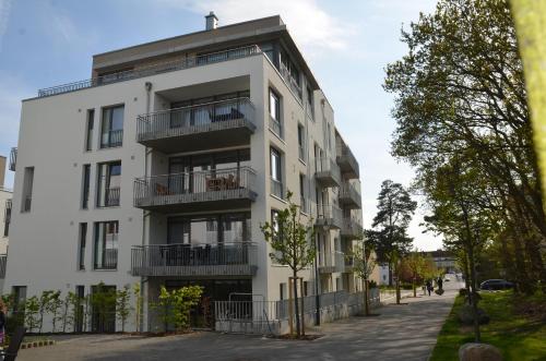 an apartment building with balconies on a street at Dünenresort Binz - Apt. 1.8 in Binz