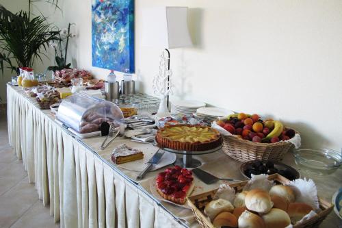a long table with a buffet of food on it at Hotel Stella Marina in San Teodoro