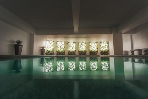 a swimming pool in a house with lights on at 1014 West Insula Suites by AYS in Manila