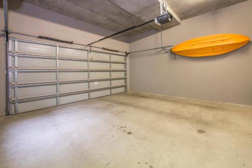 a garage with a yellow surfboard on the wall at Calm Waters in Dunsborough