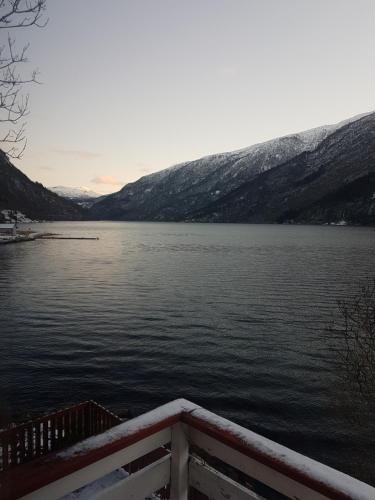 a view of a body of water with snow covered mountains at Bazyl Apartment in Folkedal