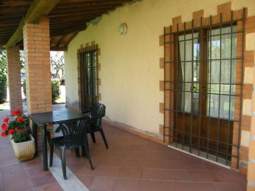 a patio with a table and chairs on a house at Agriturismo Poggio alle Calle in Saturnia