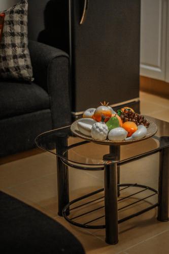 a table with a plate of fruit on top of it at 1014 West Insula Suites by AYS in Manila