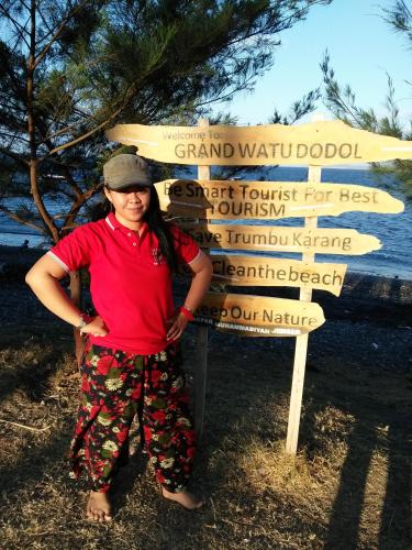 a woman is standing in front of a sign at Homestay Lidiya in Banyuwangi