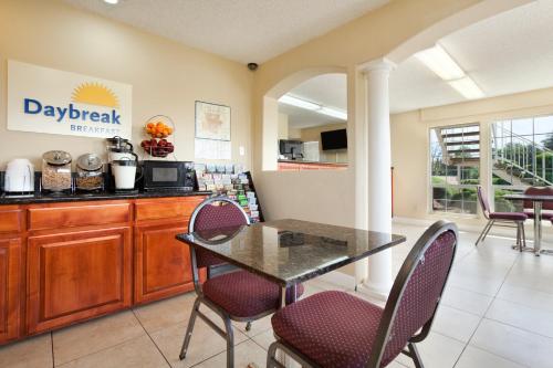 a kitchen with a table and chairs in a room at Days Inn by Wyndham Turlock in Turlock