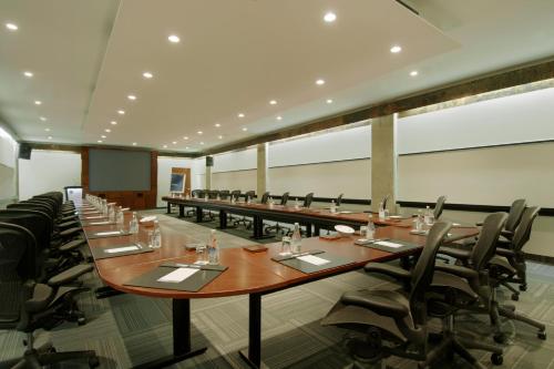 a large conference room with long tables and chairs at Novotel Montreal Center in Montréal