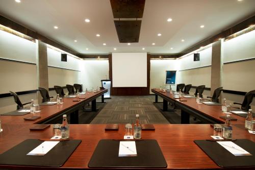a large conference room with long tables and chairs at Novotel Montreal Center in Montréal