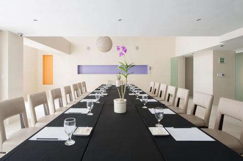 a long dining room with a long table and chairs at The Picasso Boutique Serviced Residences Managed by HII in Manila