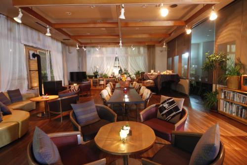 a living room with tables and chairs and a library at Matsukaneya Annex in Zao Onsen