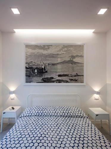 a bedroom with a bed and a painting on the wall at Relais Castel Nuovo in Naples