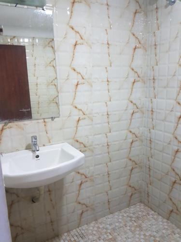 a bathroom with a sink and a mirror at Princess Residency in Nedumbassery