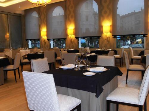 a dining room filled with tables and chairs at Gran Hotel Sardinero in Santander