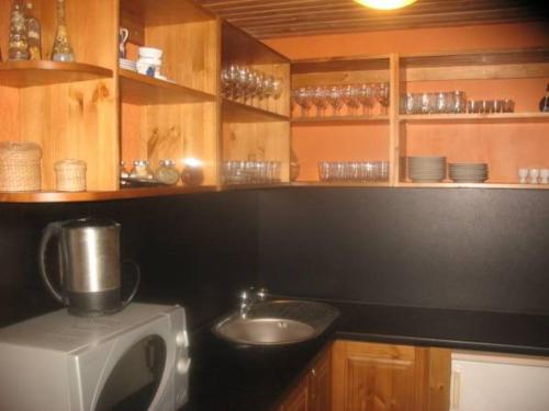 a kitchen with a microwave and a sink in it at Gliemji in Krāslava