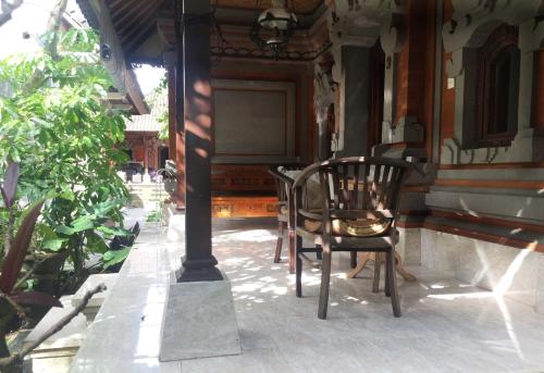 a chair sitting on the porch of a house at Bagus Homestay in Ubud