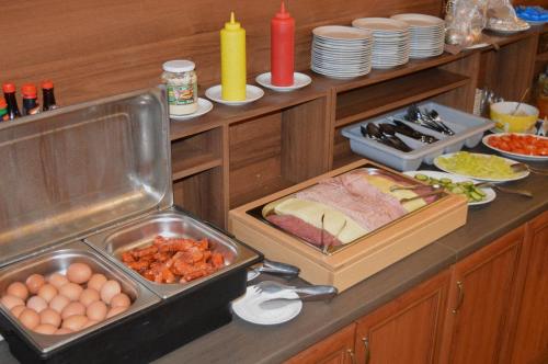 a kitchen with a counter with eggs and other food at Miramonti Apartmány in Smokovce