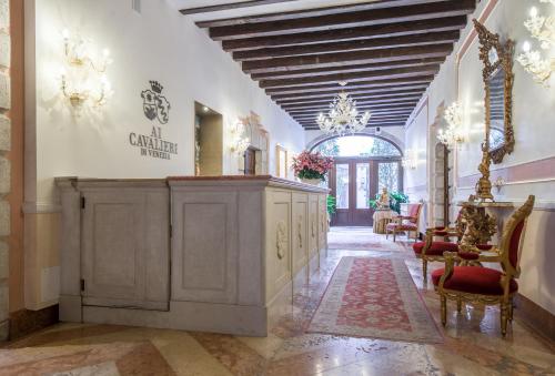 a hallway with a vanity and chairs in a building at Hotel Ai Cavalieri di Venezia in Venice