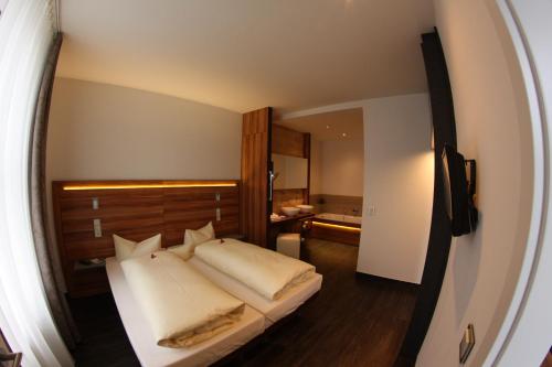 a bedroom with a large bed and a large mirror at Hotel Goldene Krone in Clausthal-Zellerfeld