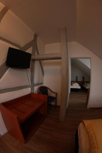 a view of a room with a bed and a desk at Hotel Goldene Krone in Clausthal-Zellerfeld