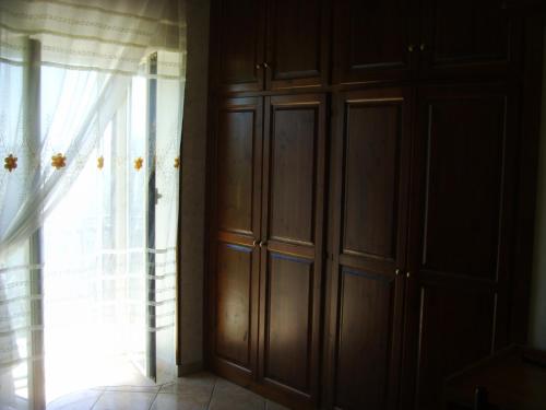 a room with wooden cabinets and a window at Casa Lieta in Subiaco