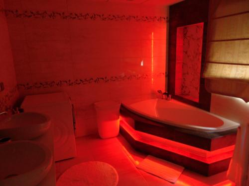 a red bathroom with a tub and a sink at Villa Altavista El Campello, Alicante in El Campello