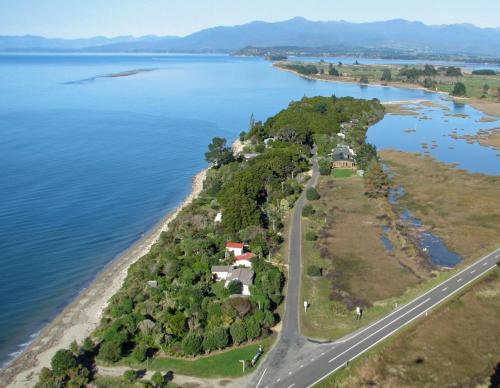 an island in the water next to a road at Twin Waters Lodge in Collingwood