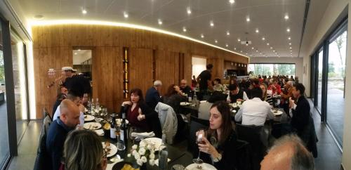 a group of people sitting at tables in a restaurant at Palazzo Tronconi agriturismo in Arce
