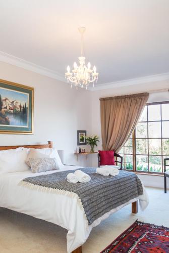 a bedroom with a large bed with towels on it at Moncrieff Manor in Knysna