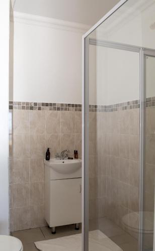 a bathroom with a sink and a shower at Moncrieff Manor in Knysna