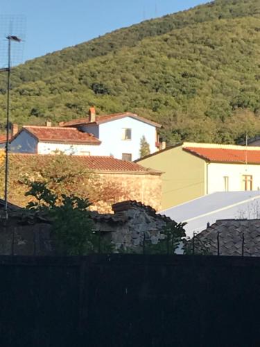 a group of buildings in front of a mountain at Vesta in Sorgono