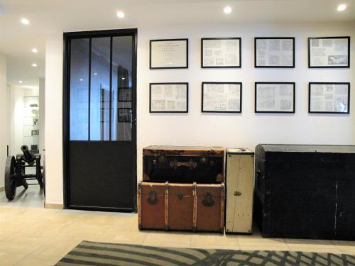 a room with a bunch of suitcases on a wall at Chalet Hôtel du Bois in Les Houches