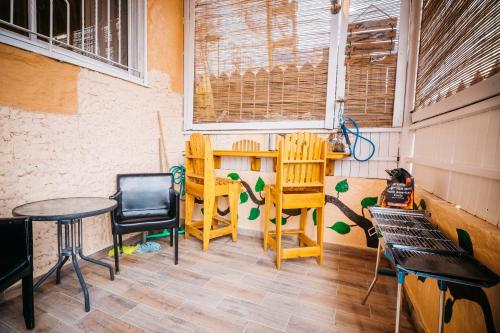 a room with two tables and chairs and a table and chairs at Asher's Apartments in Eilat