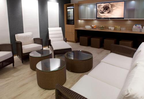 a waiting room with chairs and tables and a counter at Spa Hotel Kunnonpaikka in Kuopio