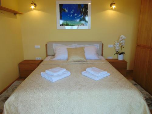 a bedroom with a bed with two towels on it at Villa Altavista El Campello, Alicante in El Campello