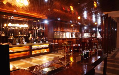 a bar in a restaurant with a table and chairs at Chang Palace Vientiane in Vientiane