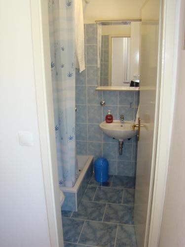 a small bathroom with a sink and a shower at Apartments Ada in Tučepi