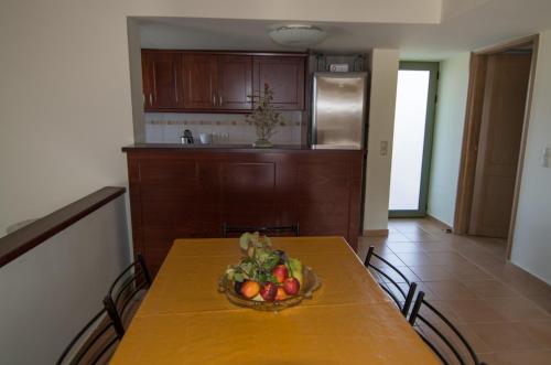 a bowl of fruit on a table in a kitchen at Ktima Nikolaos in Arónion