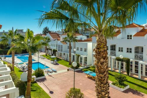 an aerial view of a resort with a pool and palm trees at Club Ouratlantico in Albufeira