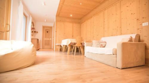 a living room with a couch and a table at Hellweger Apartments in Anterselva di Mezzo