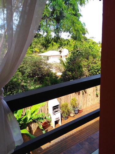 a view of a balcony with a fence and plants at L&M Housing Apartamentos y casa in Búzios