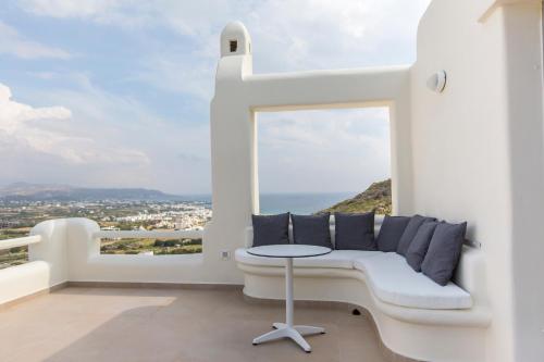 a white room with a bench and a window at Naxos Rock Villas in Stelida