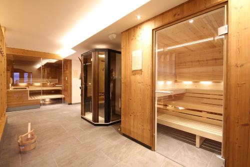 a sauna with wooden walls and a large mirror at Landhotel Laudersbach in Altenmarkt im Pongau