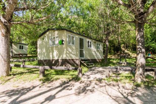 a house in the middle of some trees at Camping Alta Ribagorça in El Pont de Suert