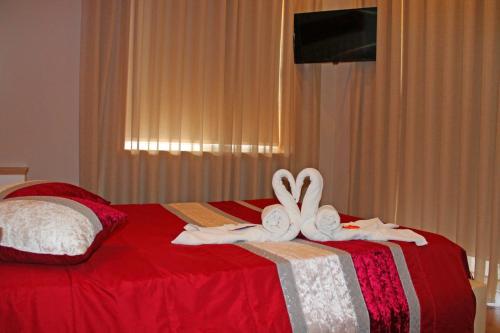 a bed with two pillows on top of it at Monte Carlo Love Porto in Porto