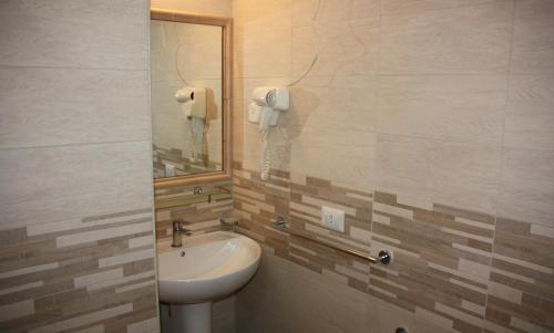 a bathroom with a sink and a phone on the wall at B&B Pontepiccolo in Catanzaro