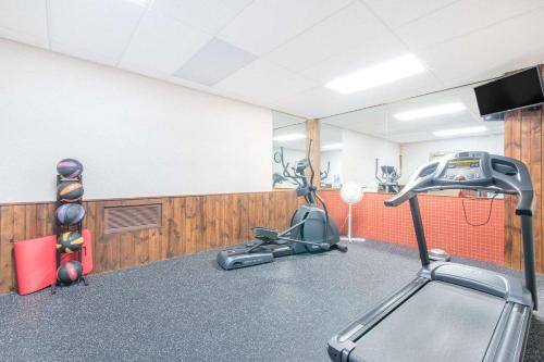 a room with a gym with a treadmill at Days Inn by Wyndham West Rapid City in Rapid City