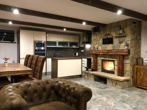 a living room with a couch and a fireplace at Ubytovanie pod Skalkou in Dolný Kubín